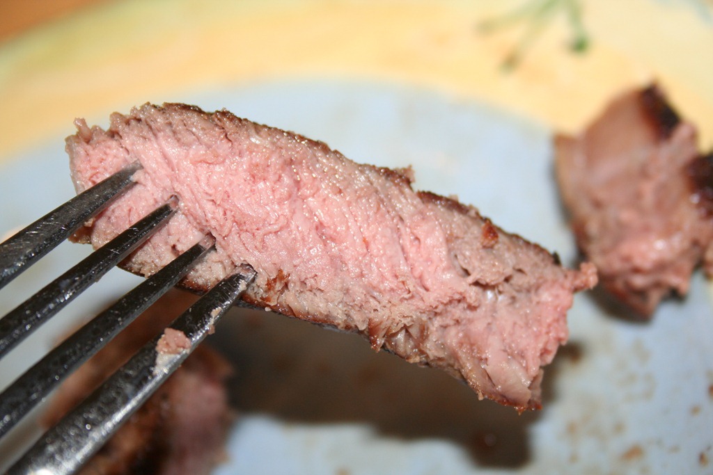Cooking rib-eye steak on a cast iron skillet